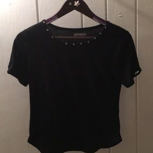 A black t-shirt with jems and slits on the sleeves